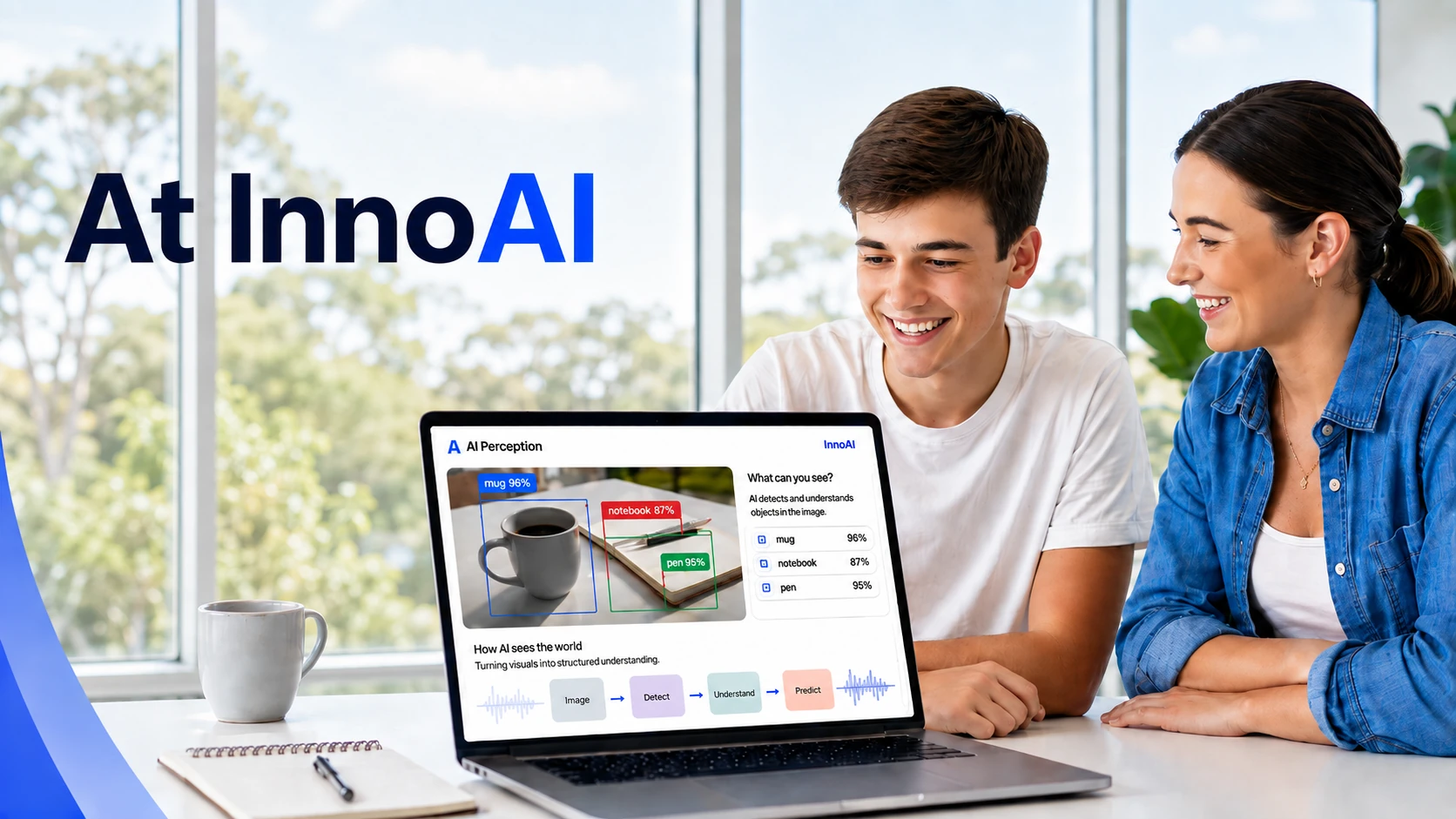 Two students smiling at a laptop running an InnoAI object-recognition app, which labels a mug, a notebook and a pen with confidence scores