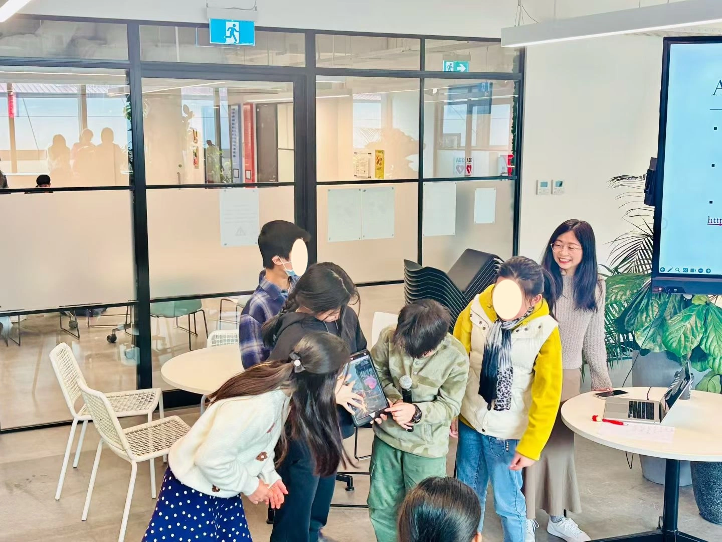 An instructor helping students with a coding challenge