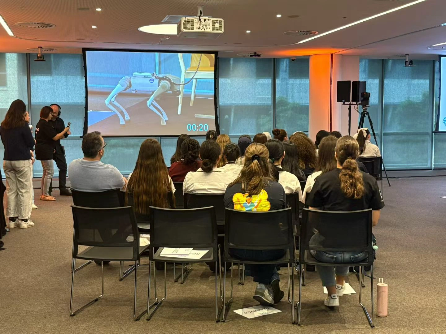Students watching a live robotics demo